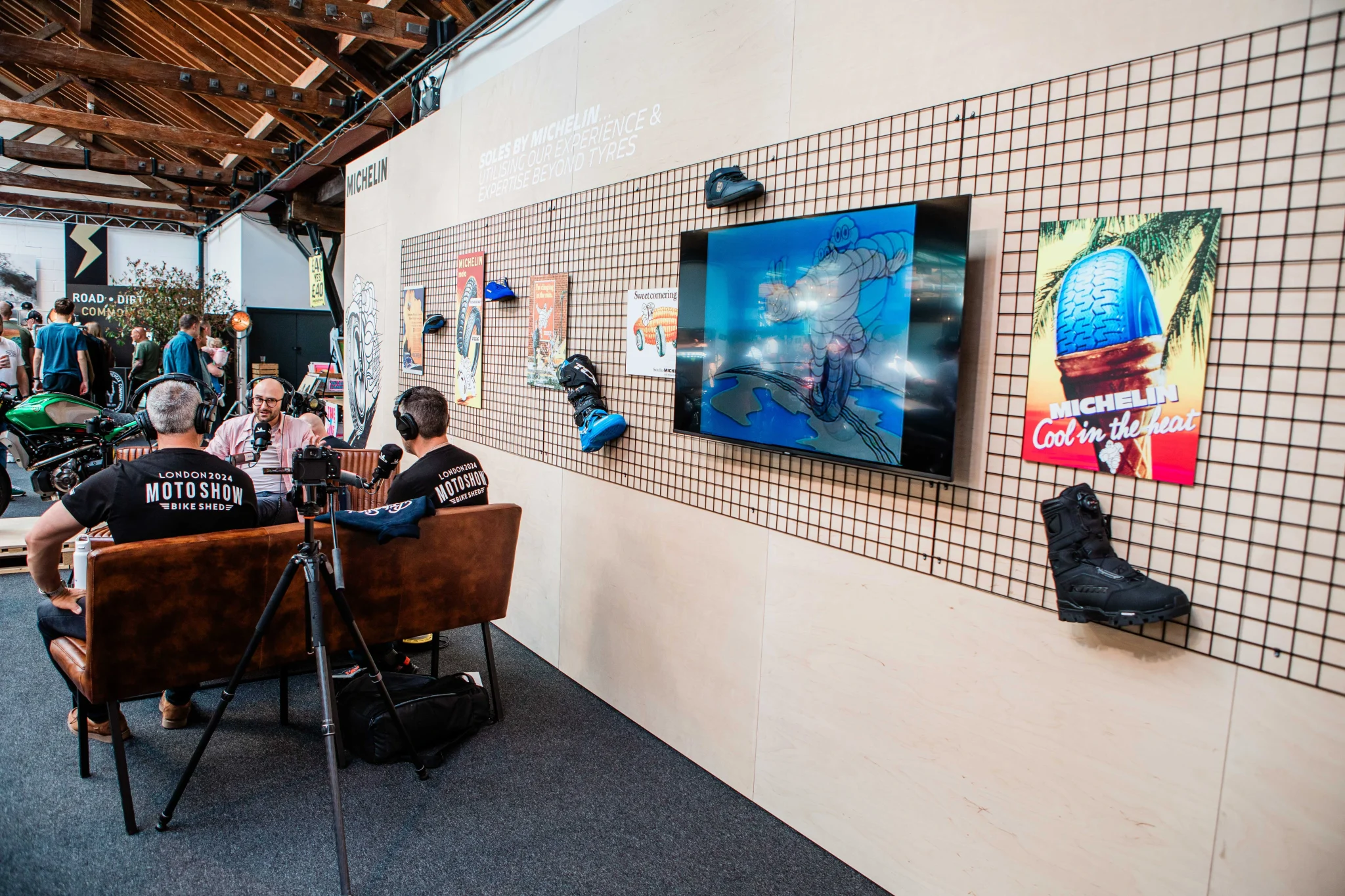 experiential stand for michelin featuring 3 men talking on a podcast in the middle of the stand